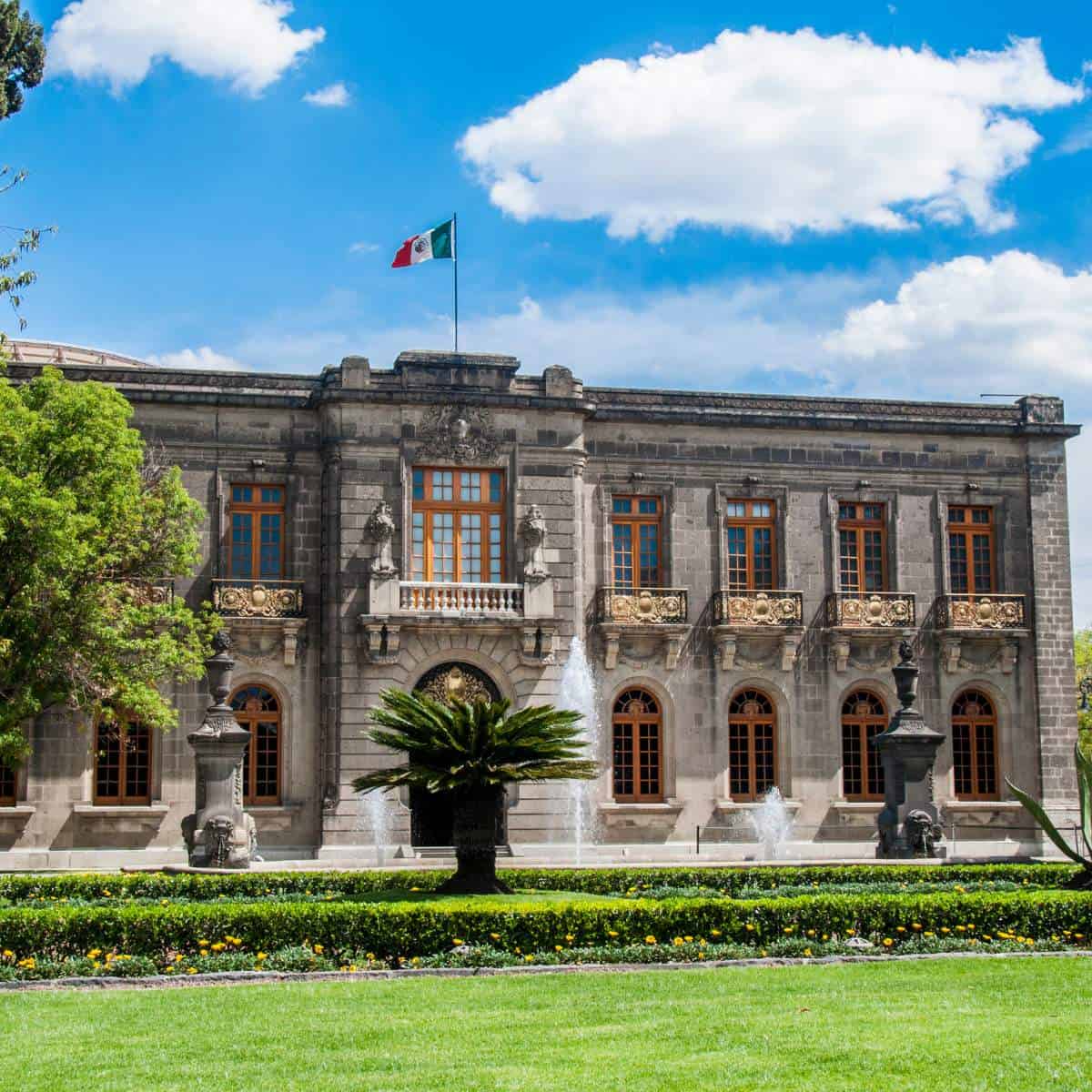 A large building with a fountain in front of it.