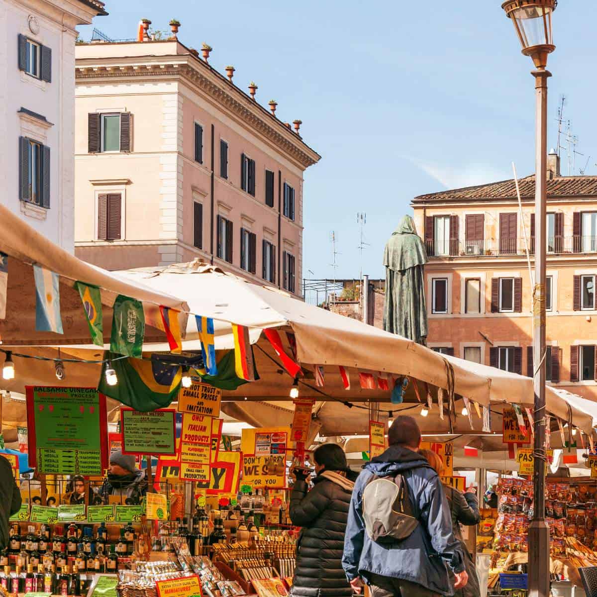A bustling outdoor market in Rome featuring mouthwatering street food options that attract people walking around.