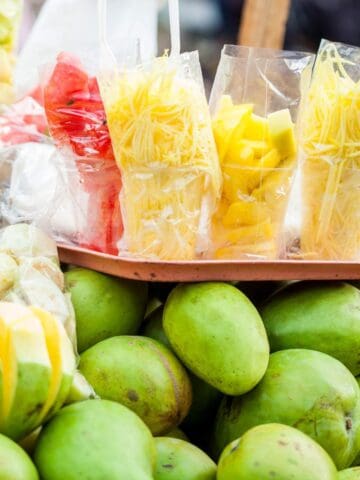 Colombian street food with a tropical twist, featuring delicious mangoes and juicy pineapples, complemented by the exotic flavors of papayas.