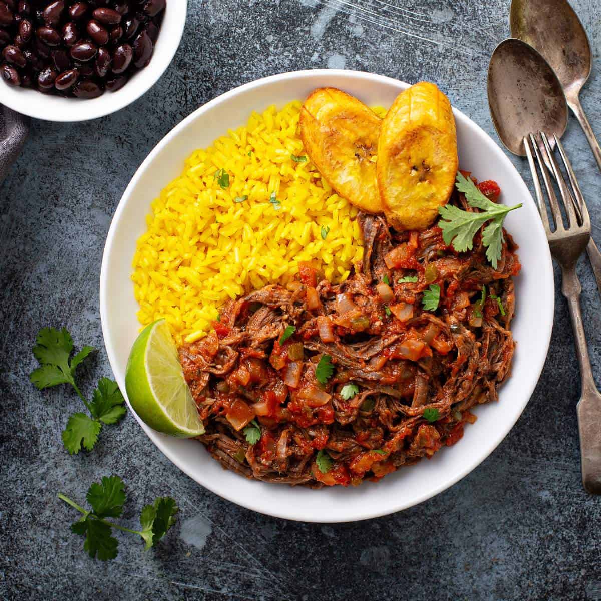 The best Cuban foods are incomplete without a bowl of rice and beans, served alongside a fork and spoon.