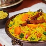 Description: A bowl of rice with vegetables in it, representing a Pakistani food dish.