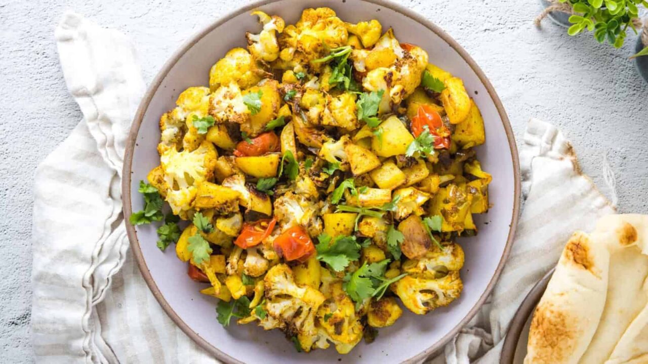An overhead image of aloo gobi in a white plate.