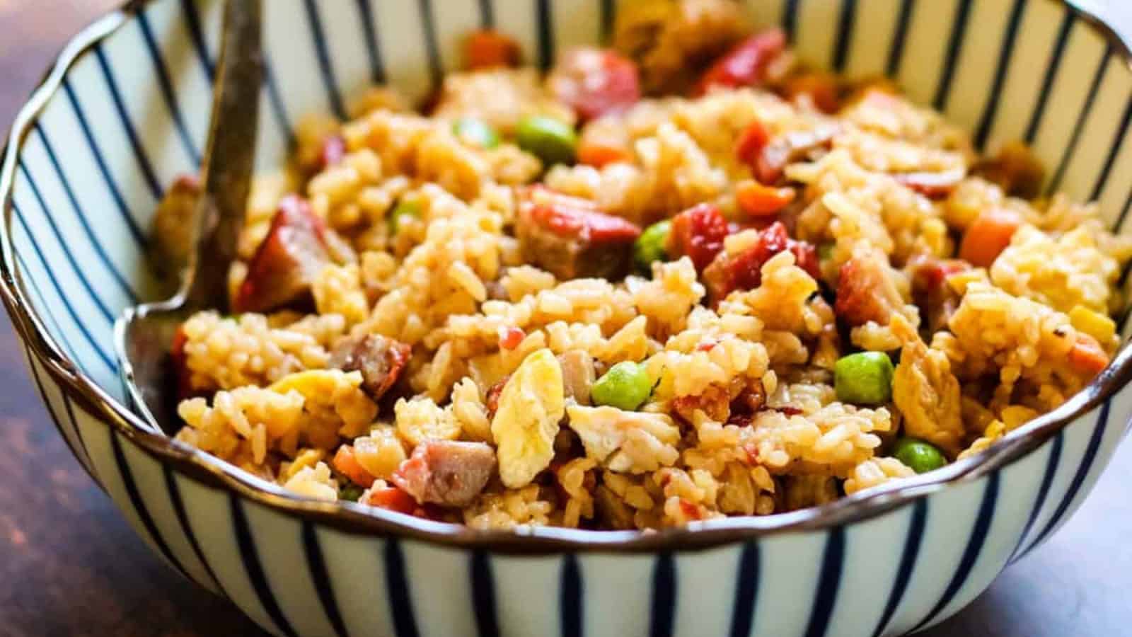 Pork fried rice in a blue and white striped bowl.