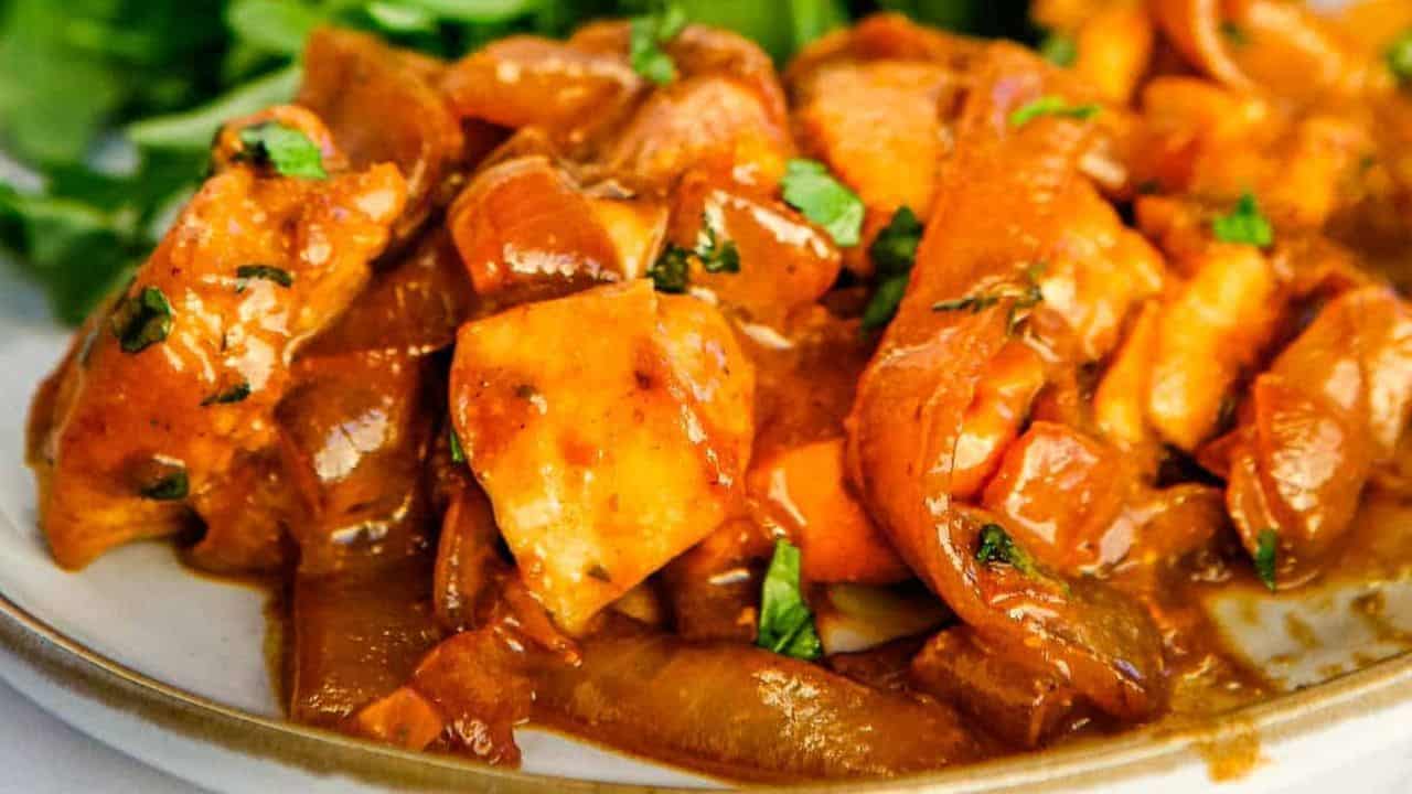 A serving of creamy balsamic chicken skillet next to a serving of green salad.