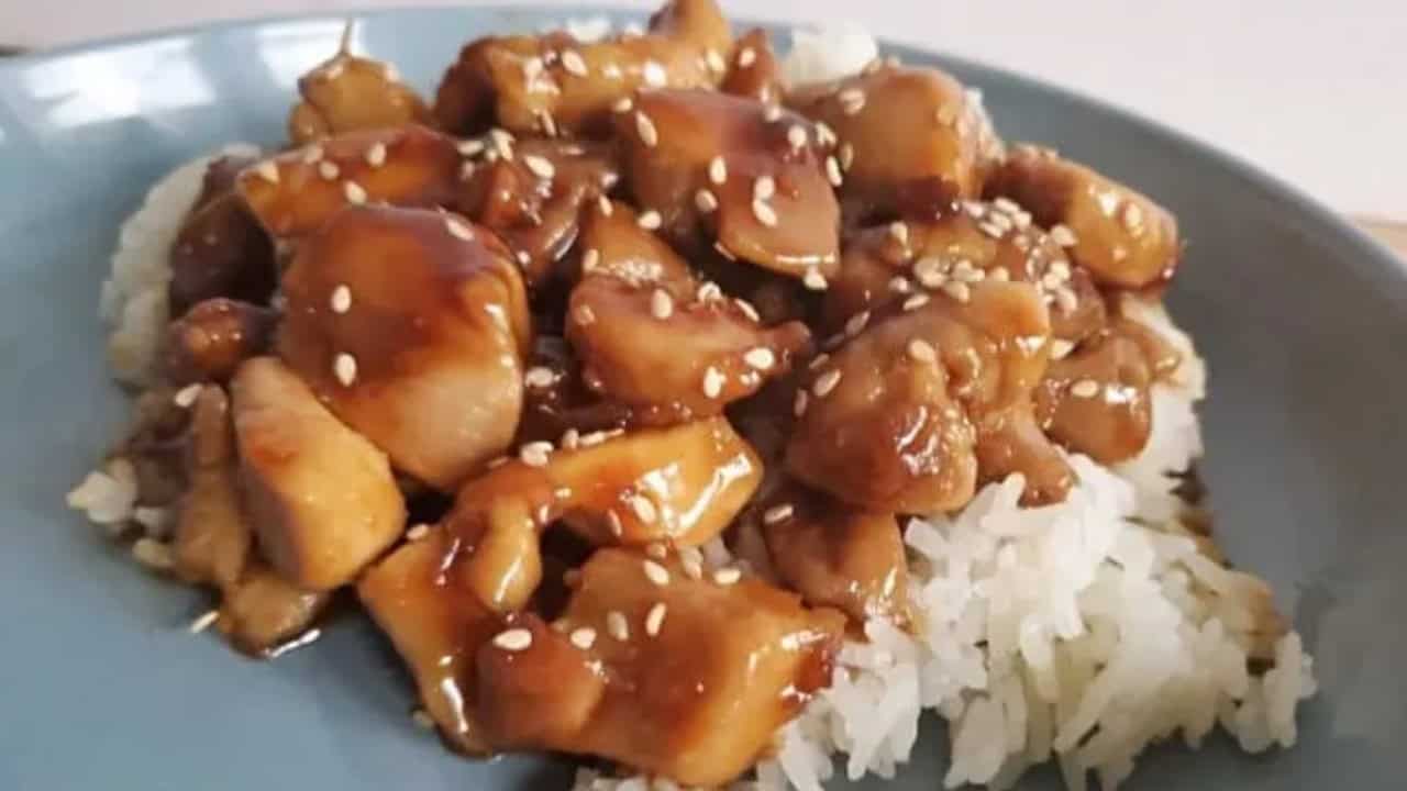 Honey glazed chicken on a blue plate.
