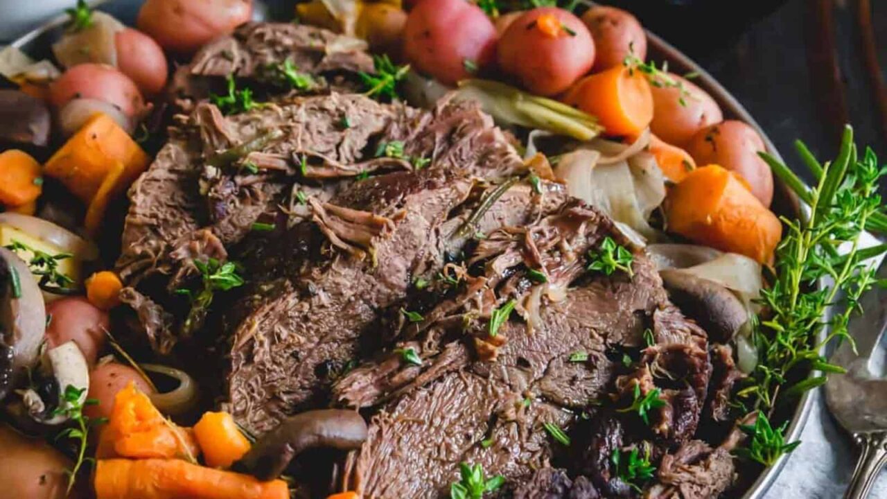 Venison roast with potatoes and carrots on a platter.
