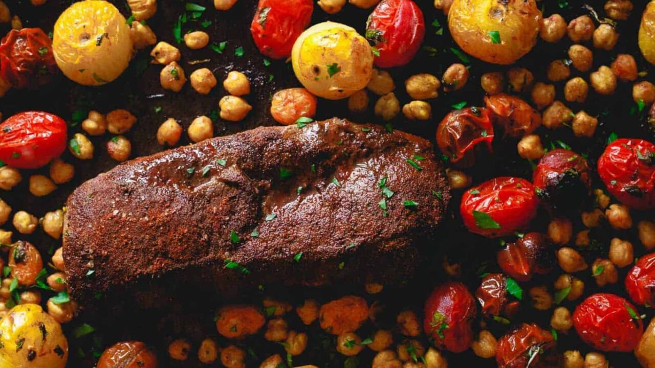 Sheet pan Mediterranean roasted lamb with tomatoes and chickpeas.