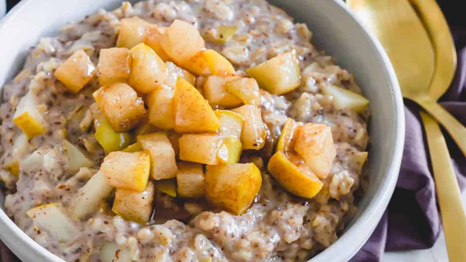 Spiced pear oatmeal in bowls with caramelized chopped pears.
