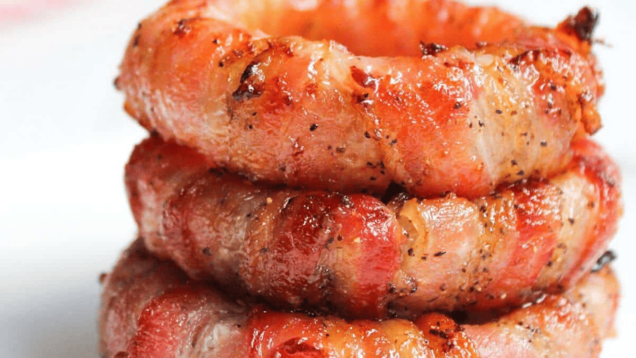 Stack of bacon wrapped onion rings.