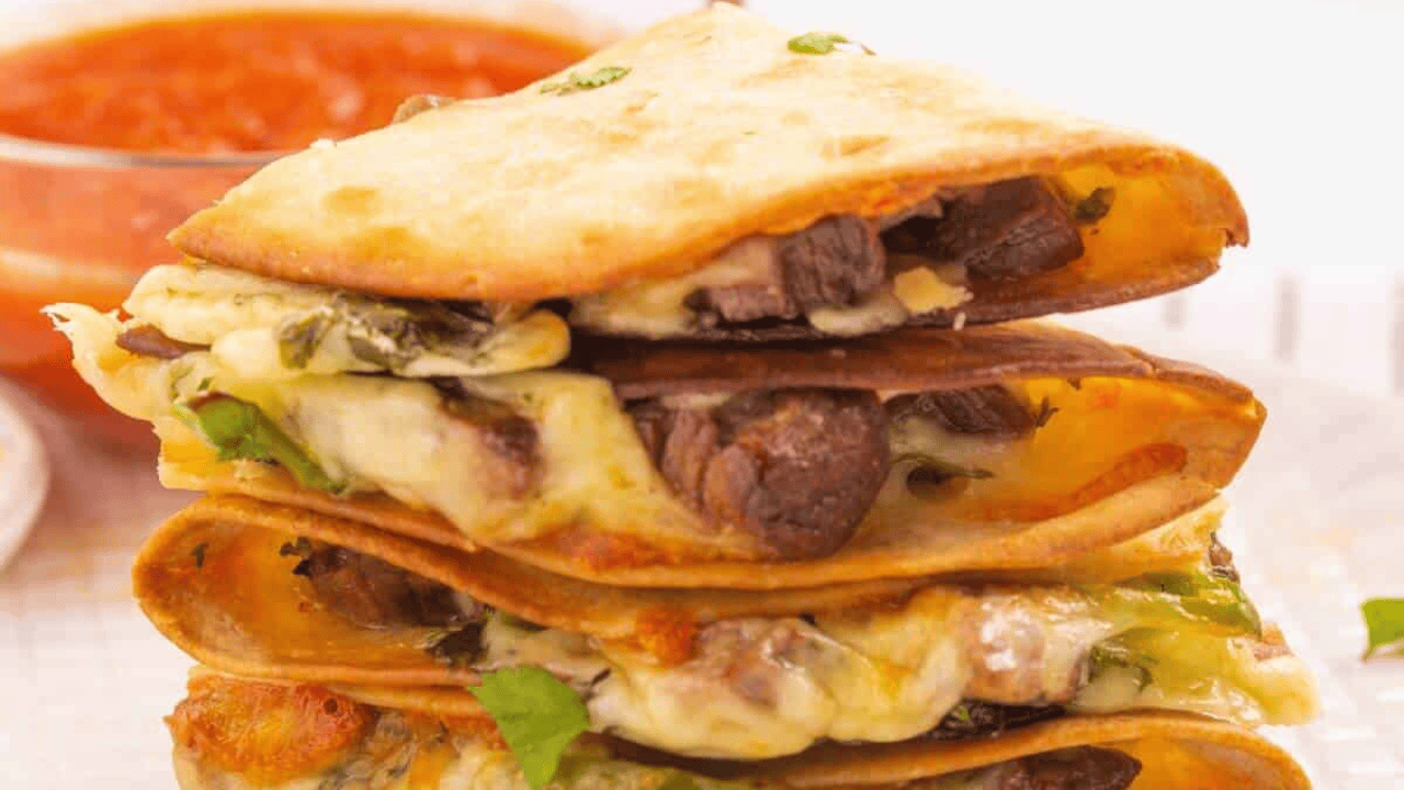 Stack of beef quesadillas on a plate.