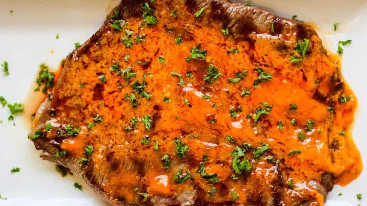 Sliced flank steak with chili butter.