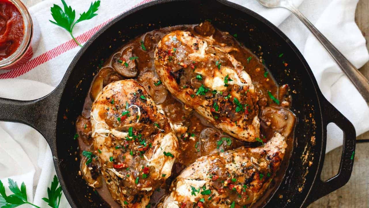Stuffed chicken marsala in a cast iron skillet.