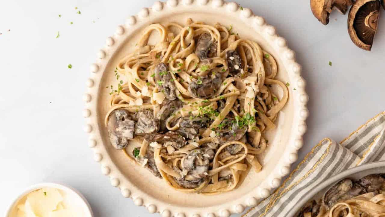 An overhead image of creamy mushroom pasta on a serving plate.