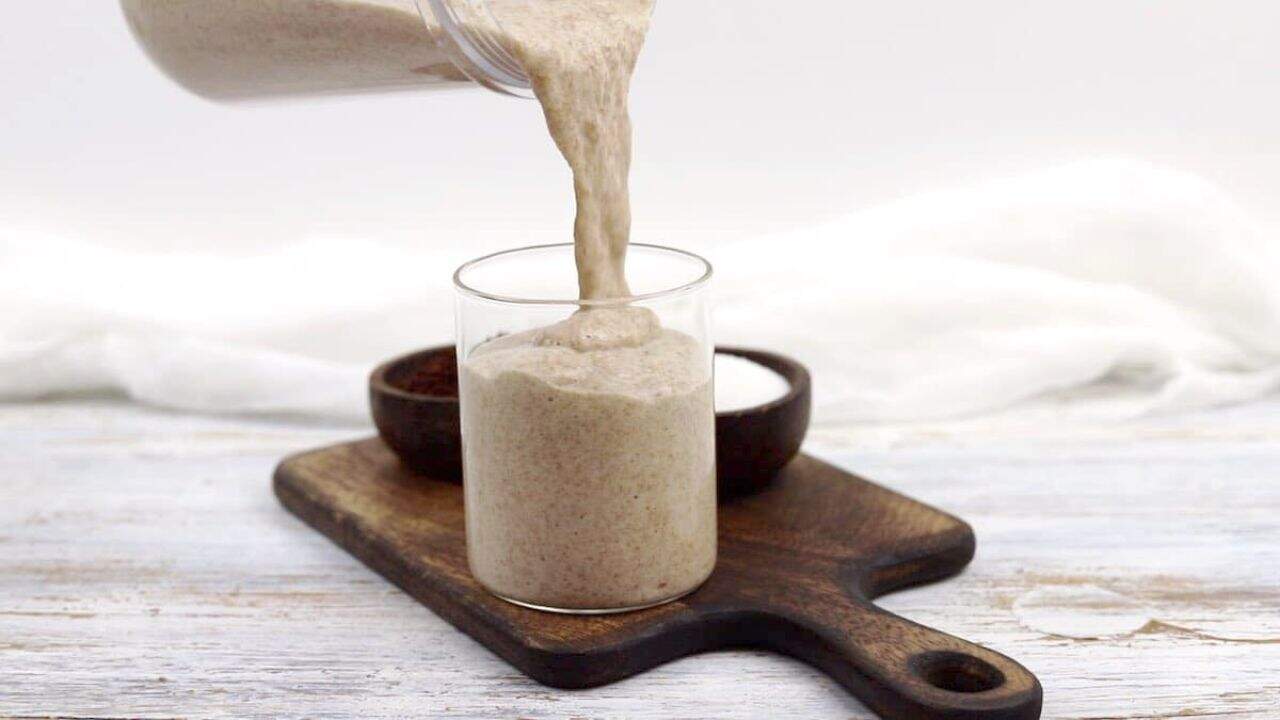 Dalgona Coffee Chia Seed Pudding in a glass with a straw.