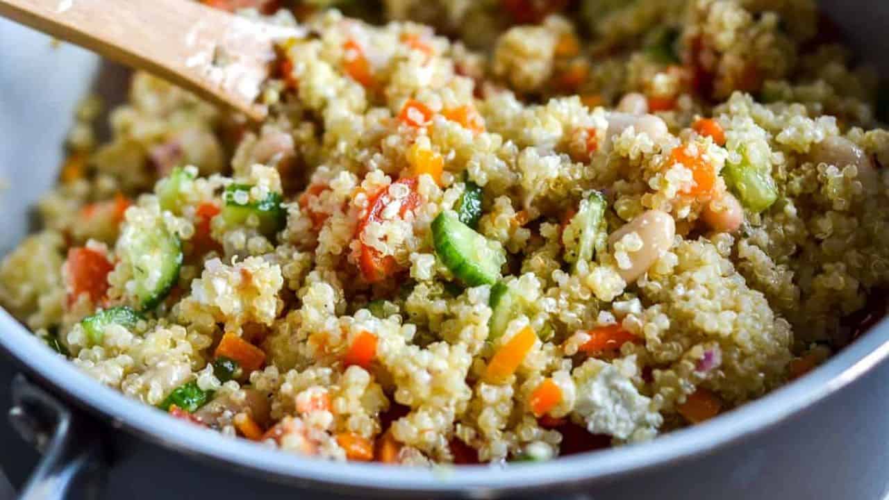 Quinoa salad in a brown bowl, garnished with pita bread.