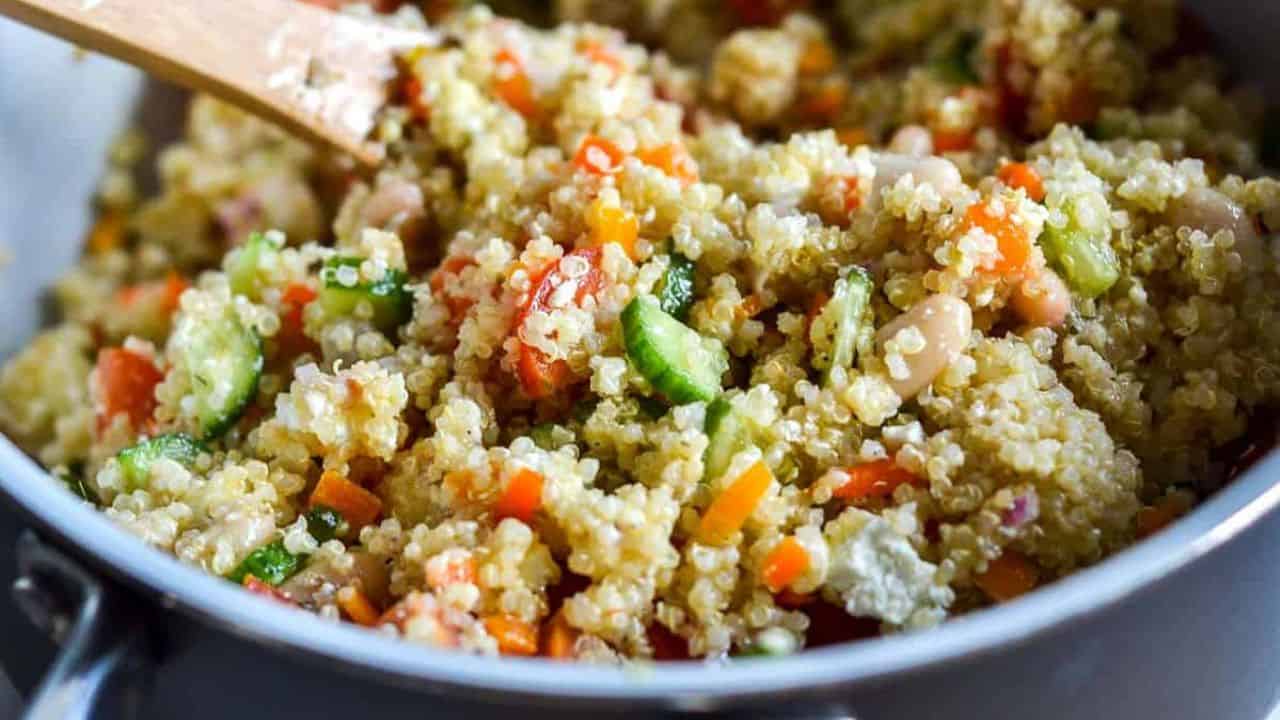 Quinoa salad in a brown bowl, garnished with pita bread.