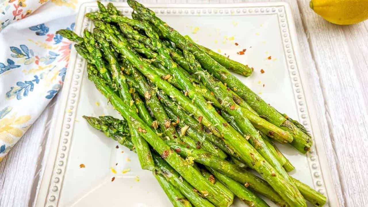 Grilled Asparagus on a white square plate.