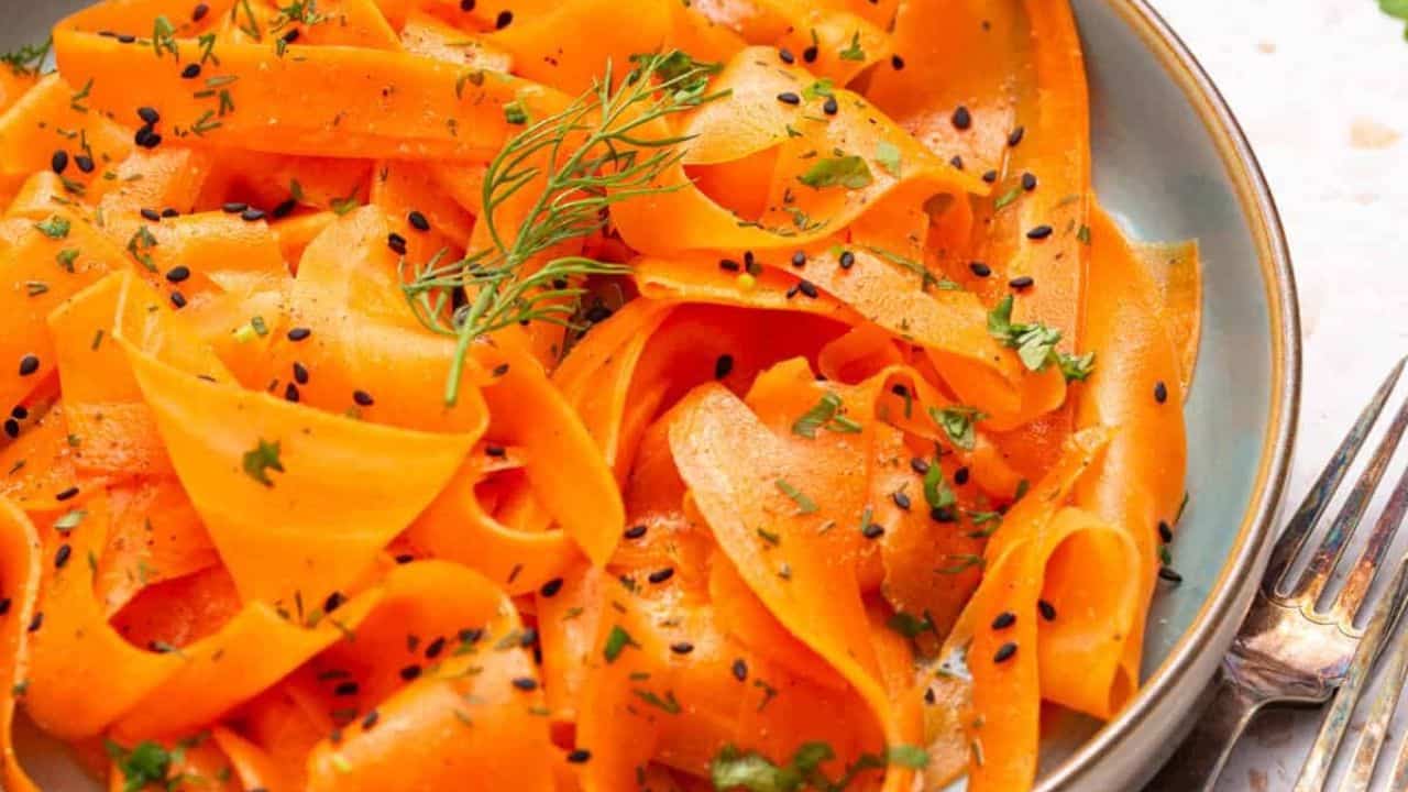 An overhead image of raw carrot salad on a plate.