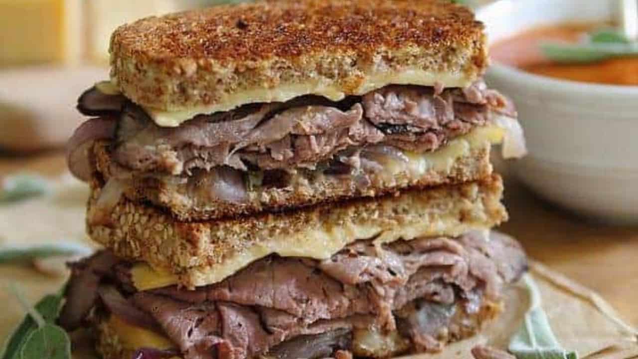 Smoked gouda roast beef grilled cheese cut in half and stacked.