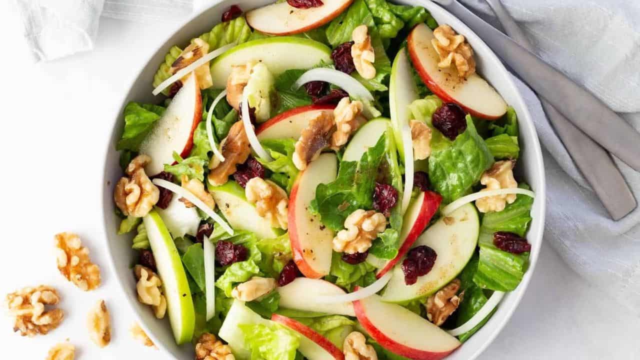 A fresh apple cranberry salad with a bright red and green color.