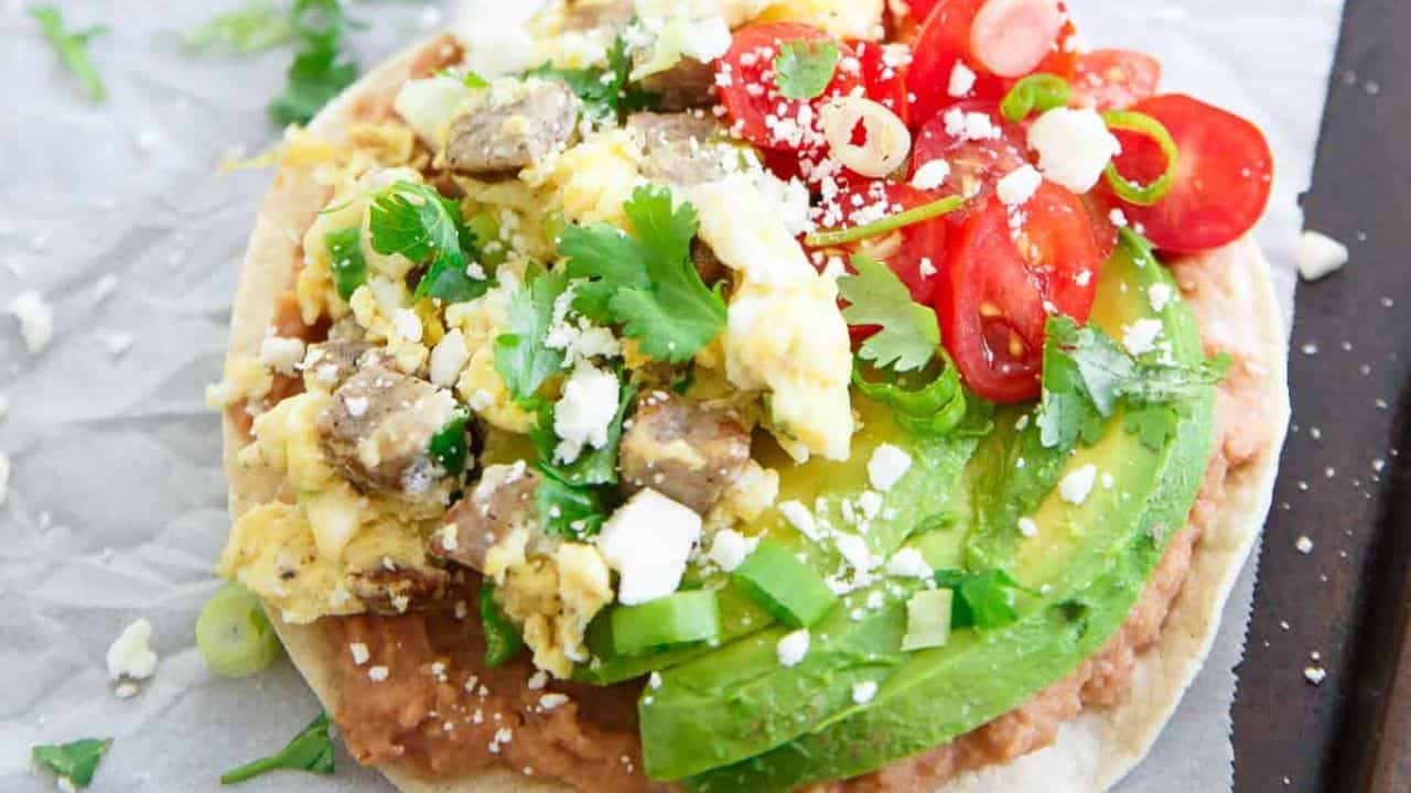 Chicken sausage breakfast tostadas with on parchment paper.