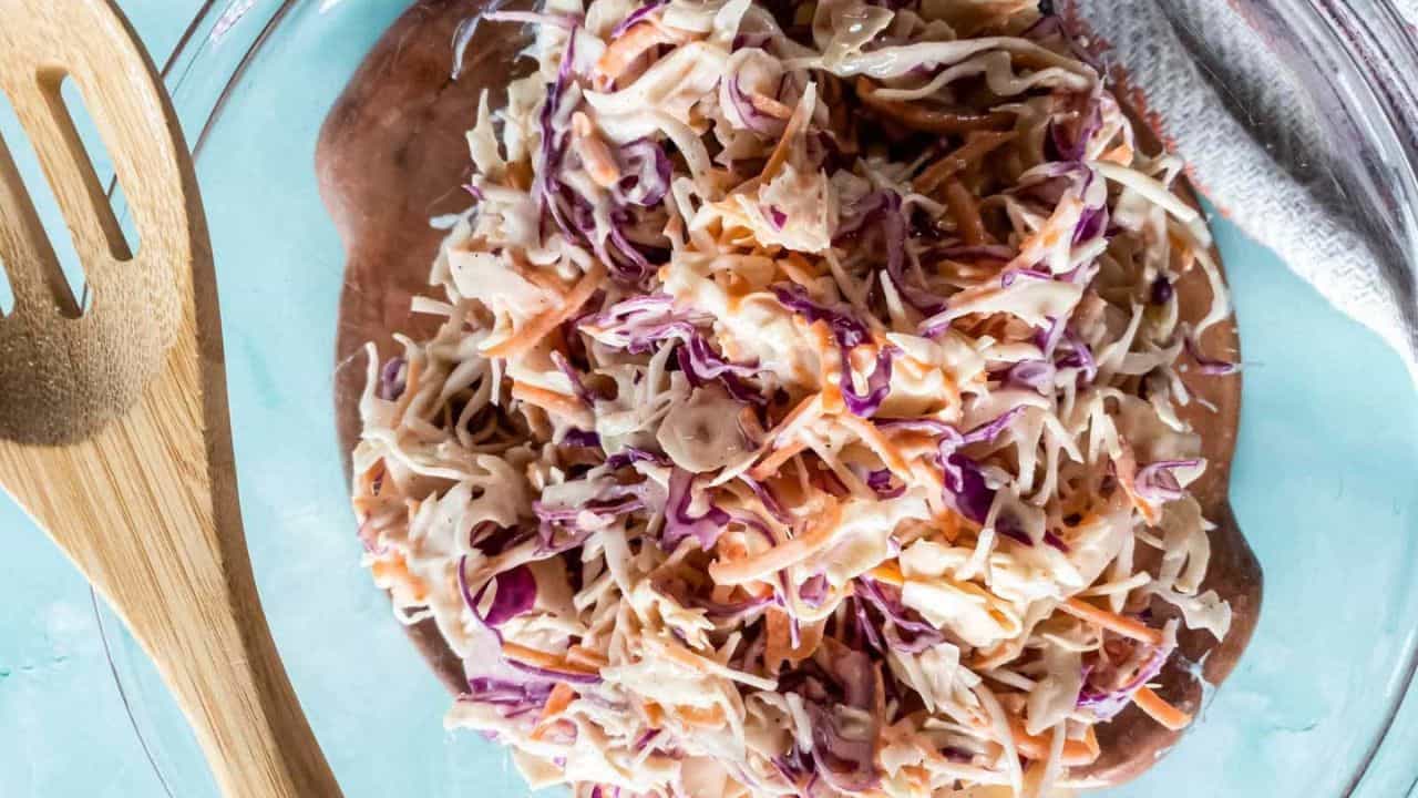 A picture of low-carb coleslaw recipe with creamy dressing in glass bowl.