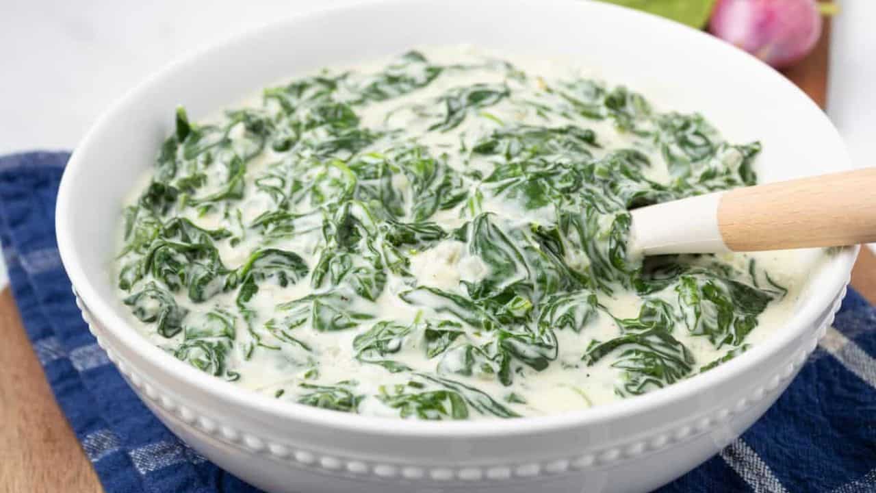 A close up image of creamed spinach in a bowl.