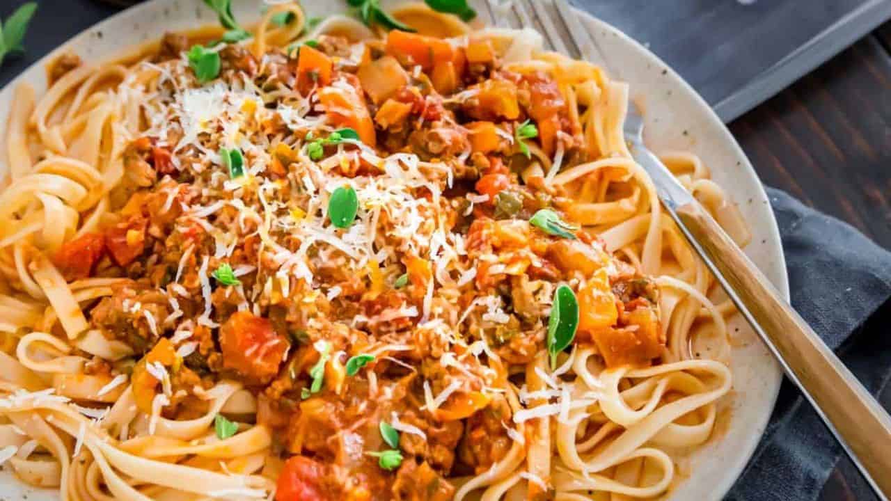 Instant Pot bolognese recipe on a plate with a fork.