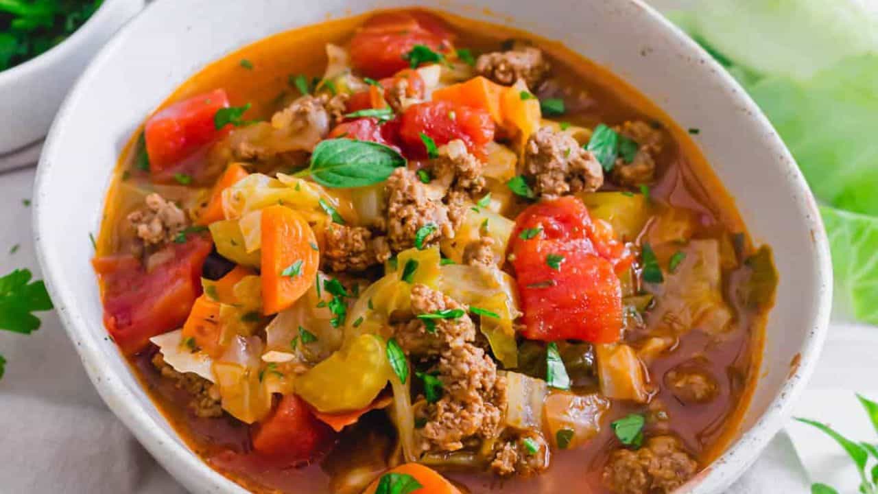 Ground beef cabbage soup made in the Instant Pot in a white serving bowl.