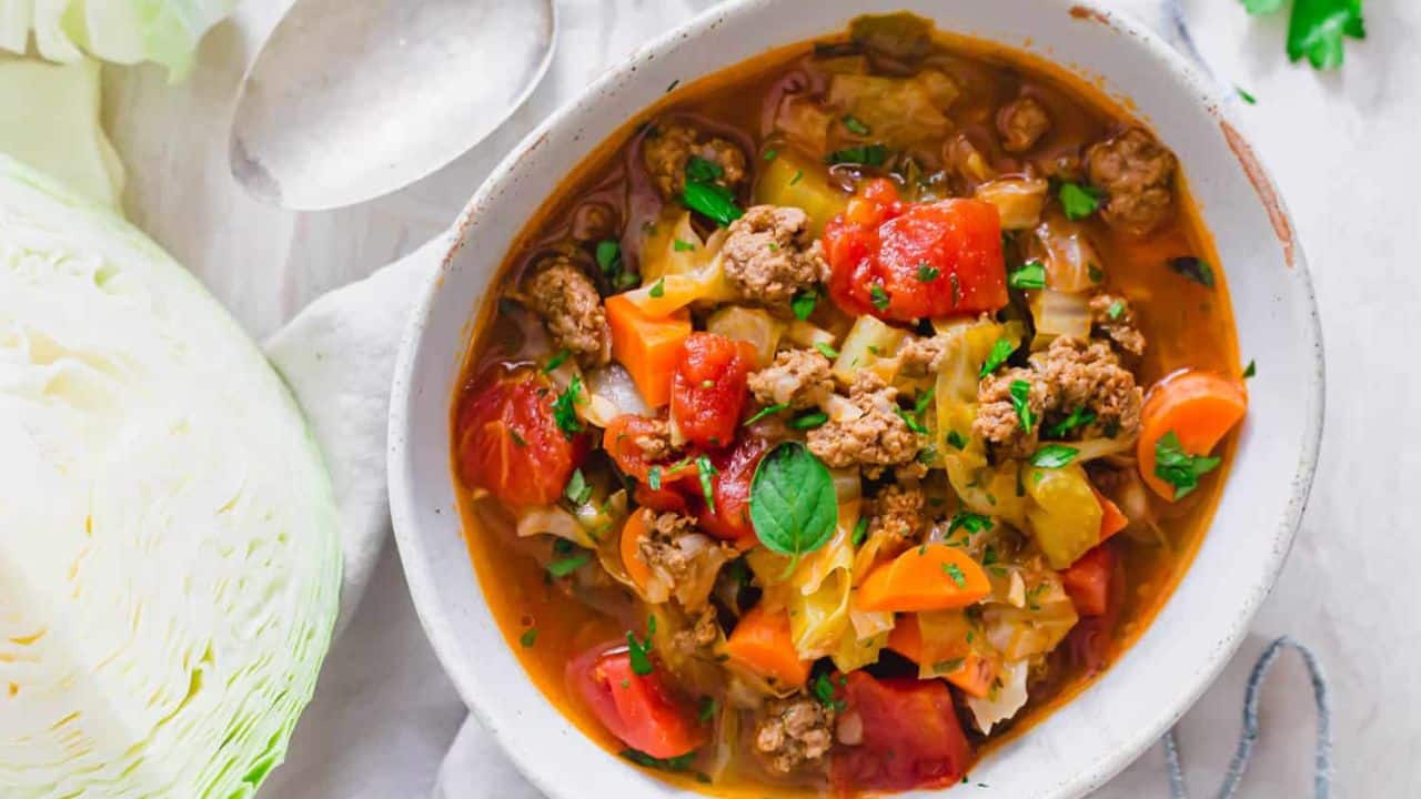 Ground beef cabbage soup made in the Instant Pot in a white serving bowl.
