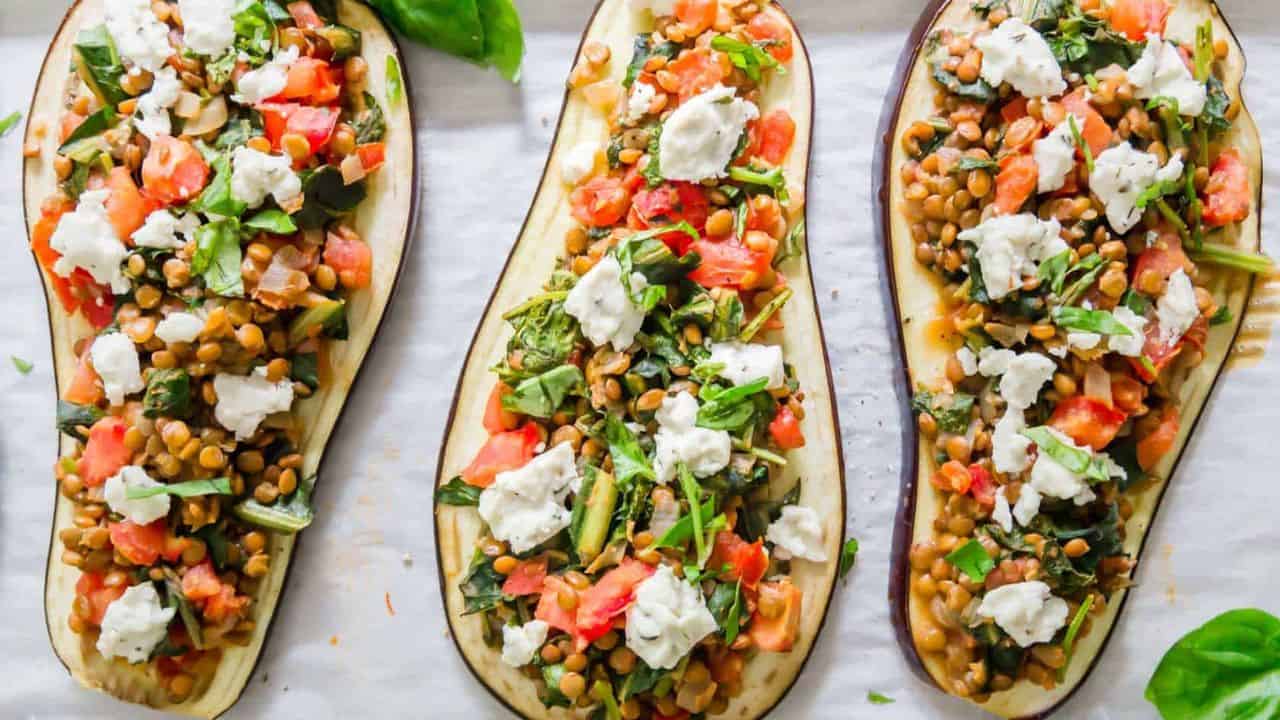 Eggplant slices on a baking sheet topped with lentil stuffing.