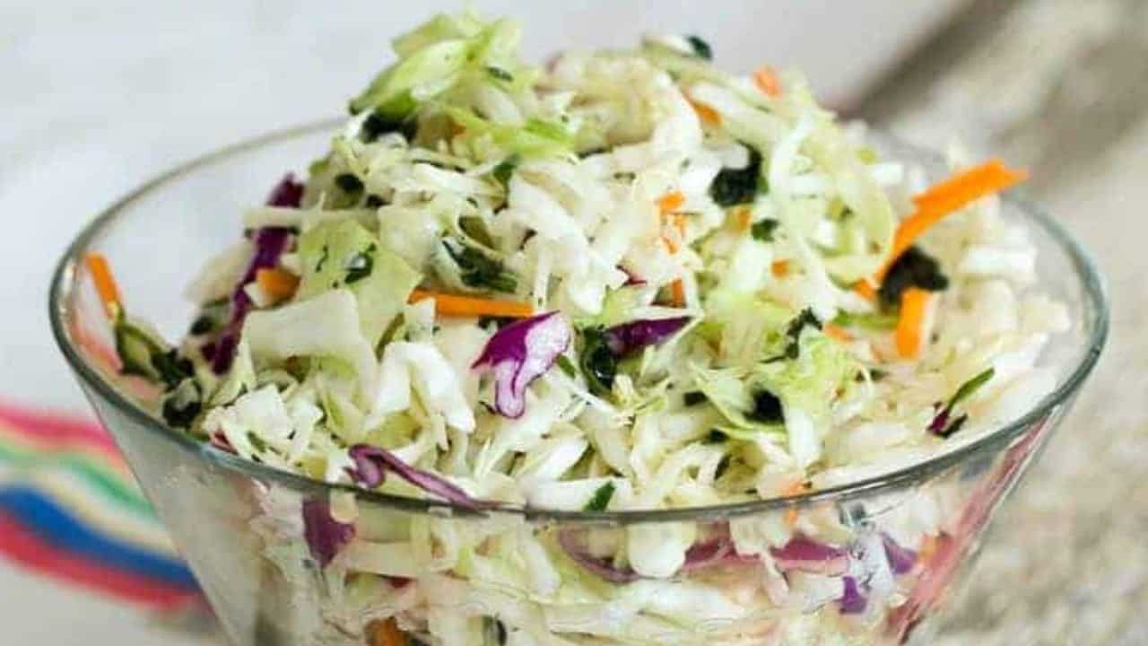 A bowl of Mexican coleslaw salad with colorful shredded cabbage.