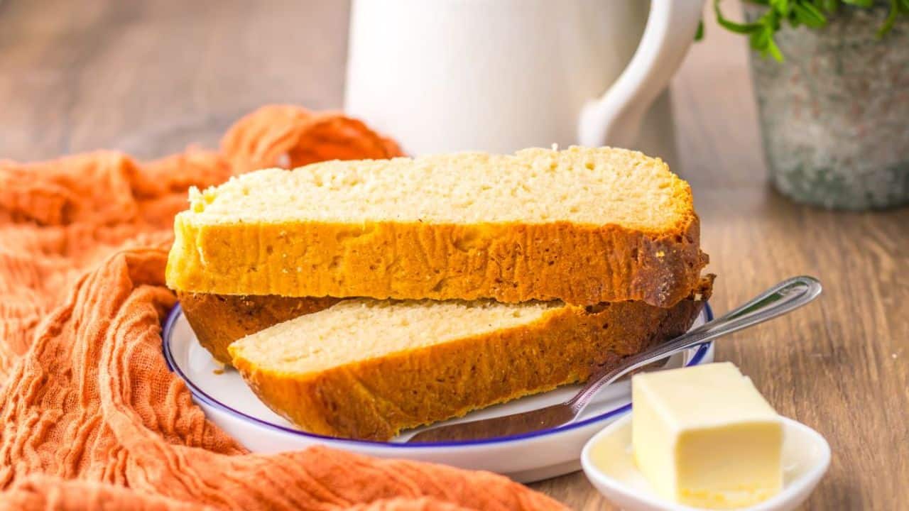 Two slices of homemade bread on white plate.