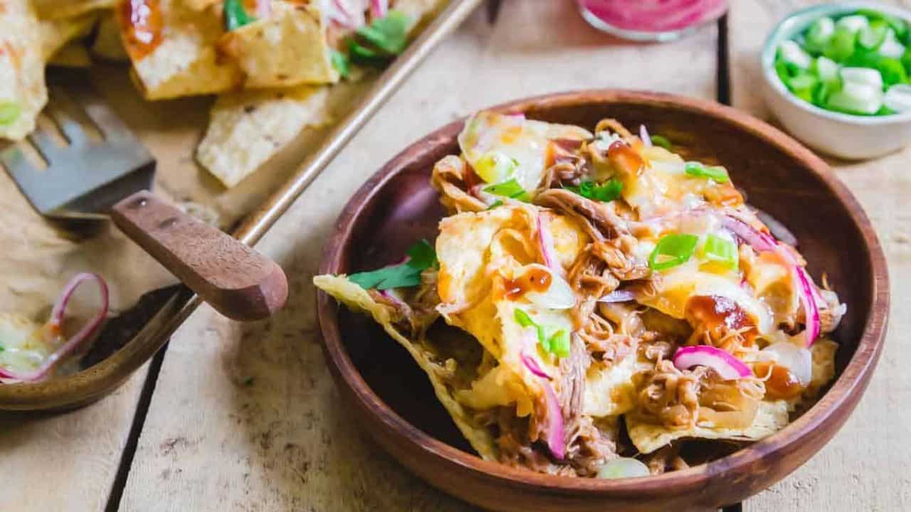 BBQ pulled pork nachos on a plate.