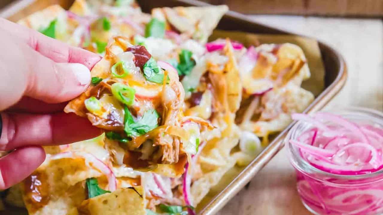 BBQ pulled pork nachos on a plate.