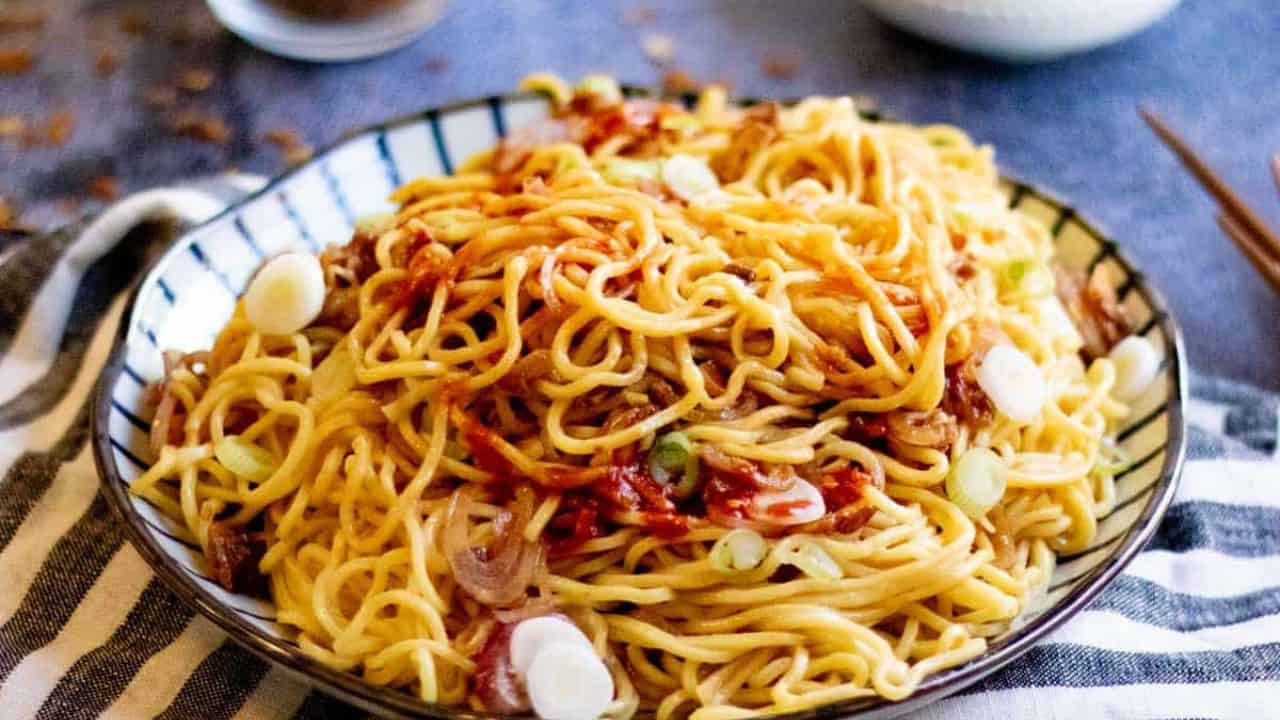 Low angle shot of a plate of burmese garlic noodles.
