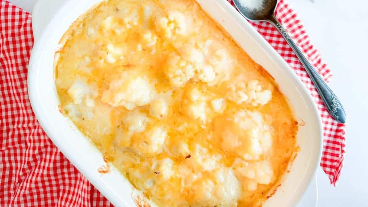Cheese sauce over cauliflower in a casserole.
