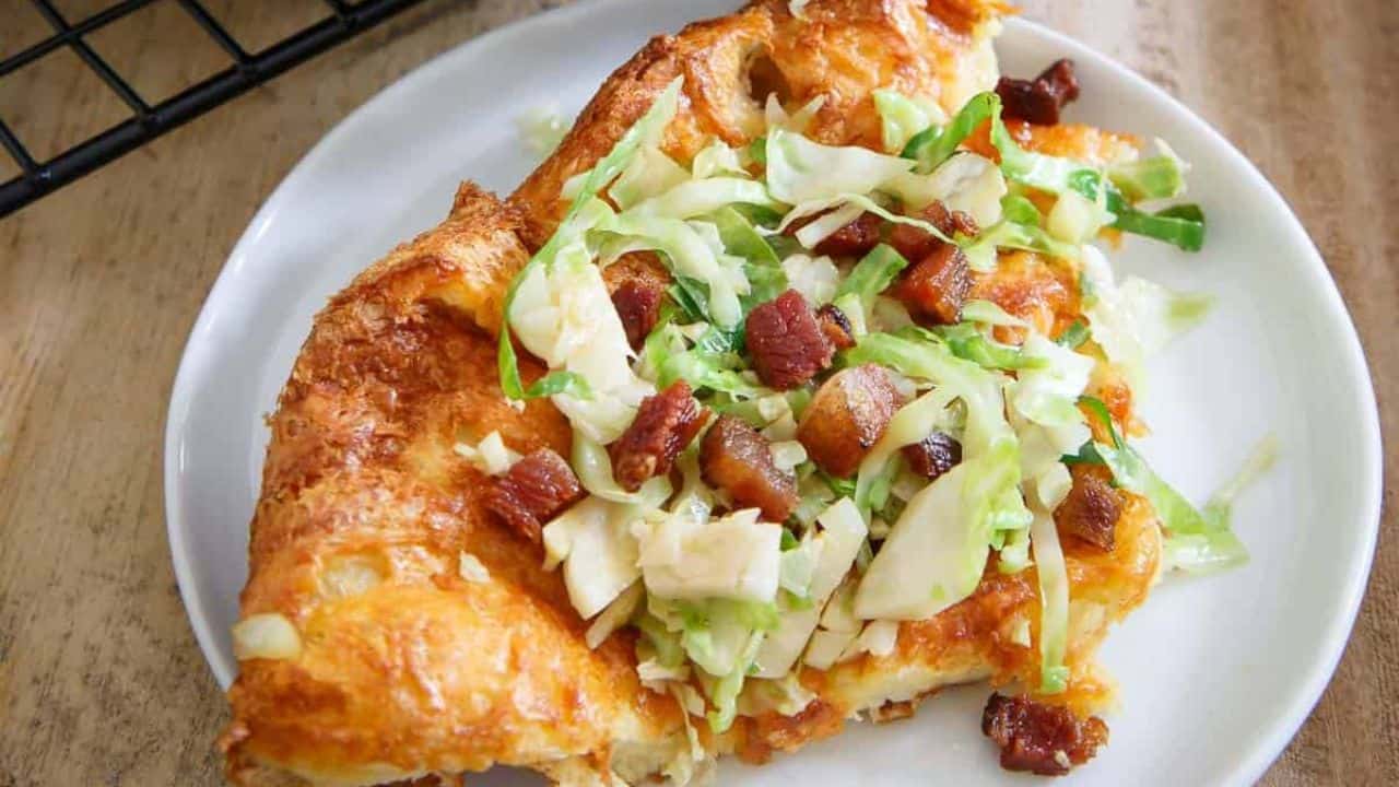 Cheddar bacon Dutch baby pancake in a cast iron skillet.