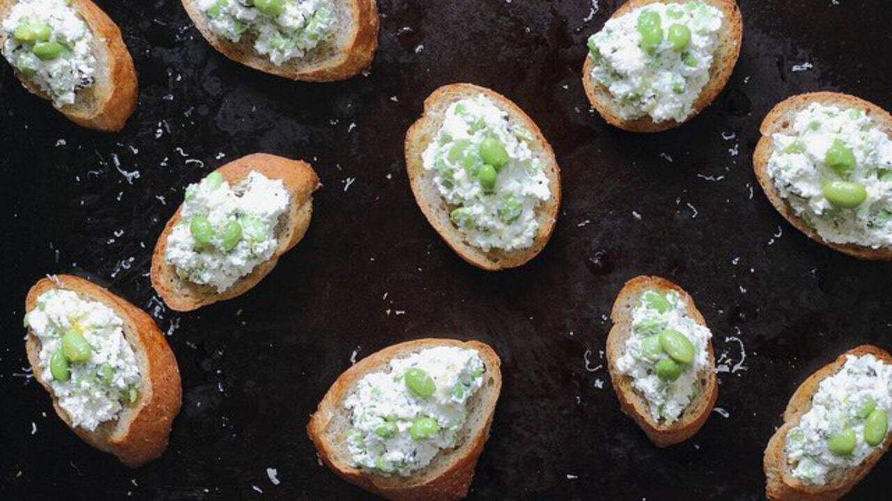 Crostini with cheesy edamame spread.