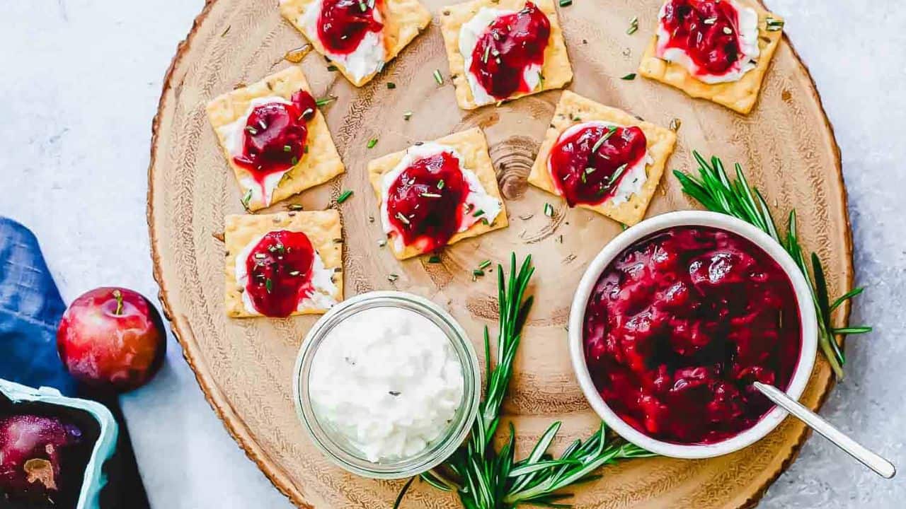Chinese 5 spice plum jam in a white bowl with a small spoon.