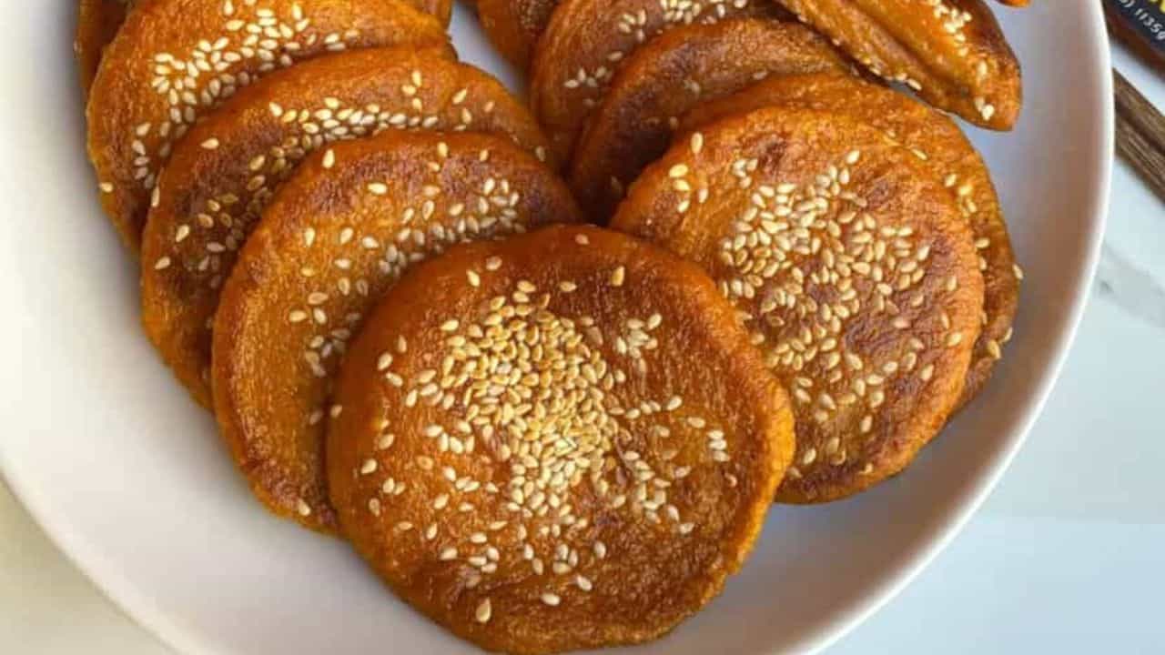 Pan-fried soft and slightly sweet Chinese pumpkin cake on a white plate.