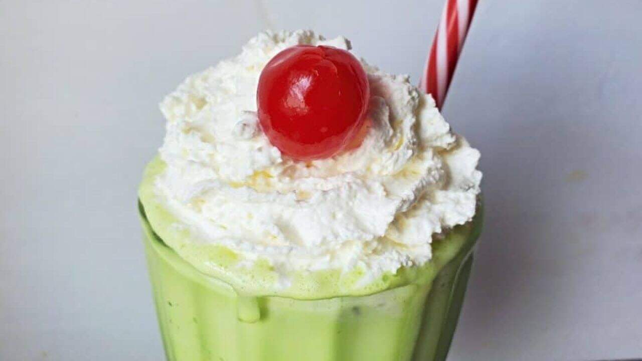 Copycat shamrock shake with whipped cream and cherry.
