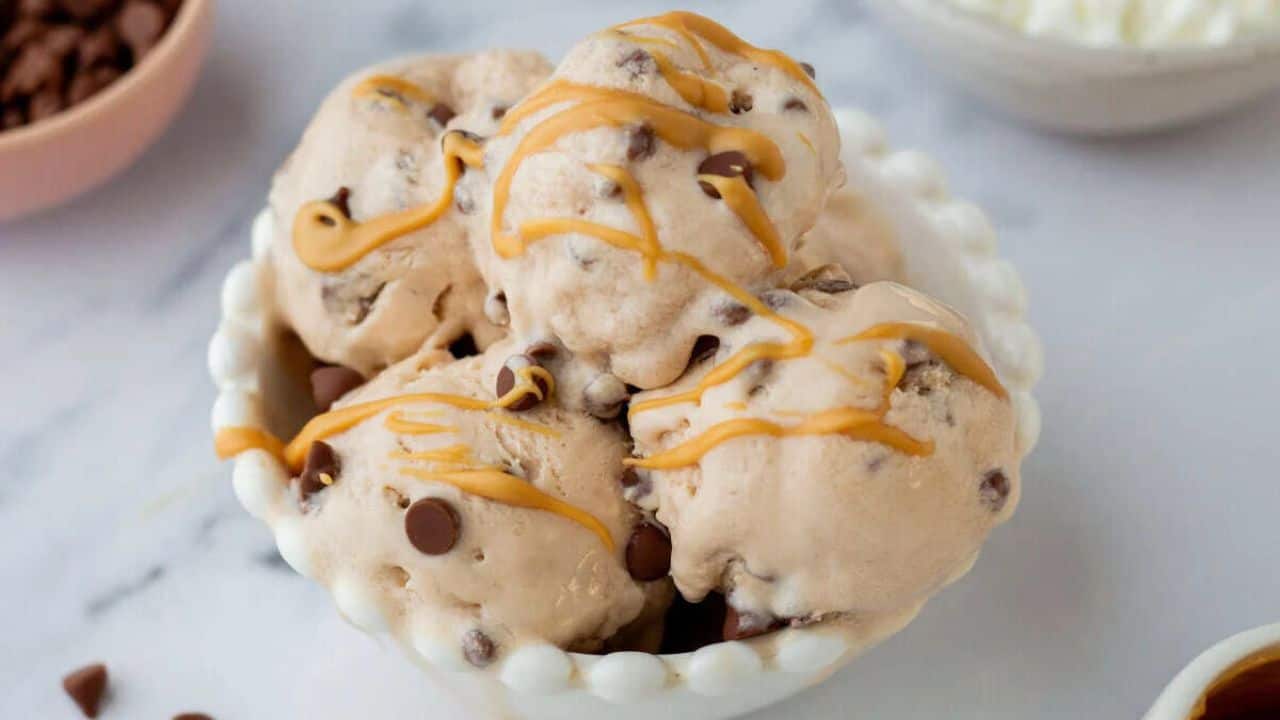 A close up image of cottage cheese ice cream drizzled with peanut butter.