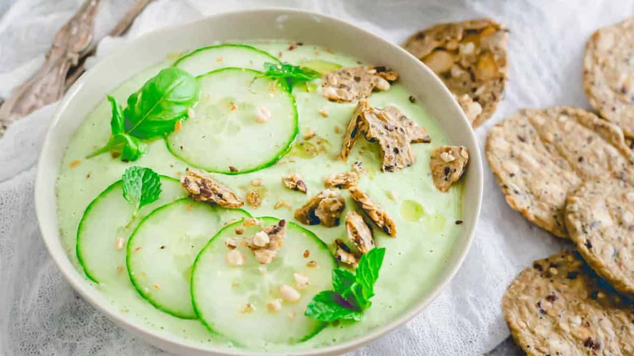 Cucumber gazpacho in bowls with crumbled crackers as garnish.
