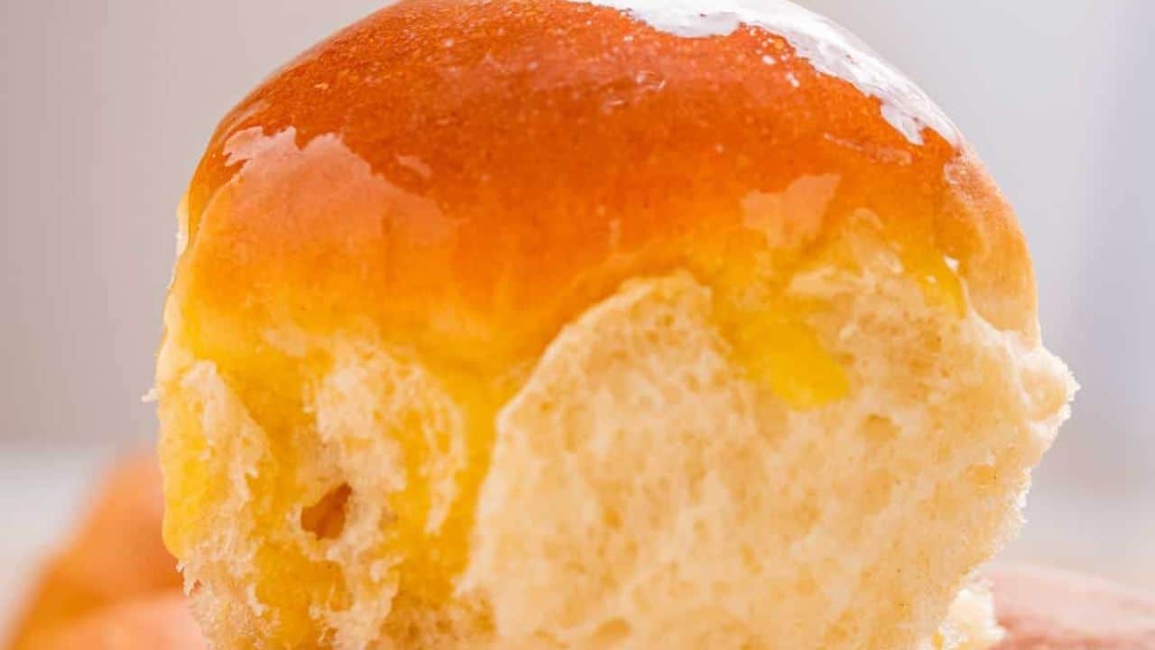 Close-up of a batch of a golden-brown dinner rolls.