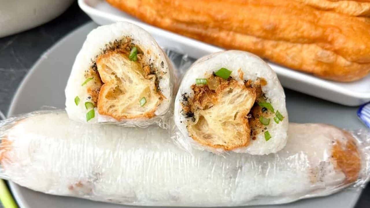 Savory Chinese stuffed sticky rice rolls on a plate.