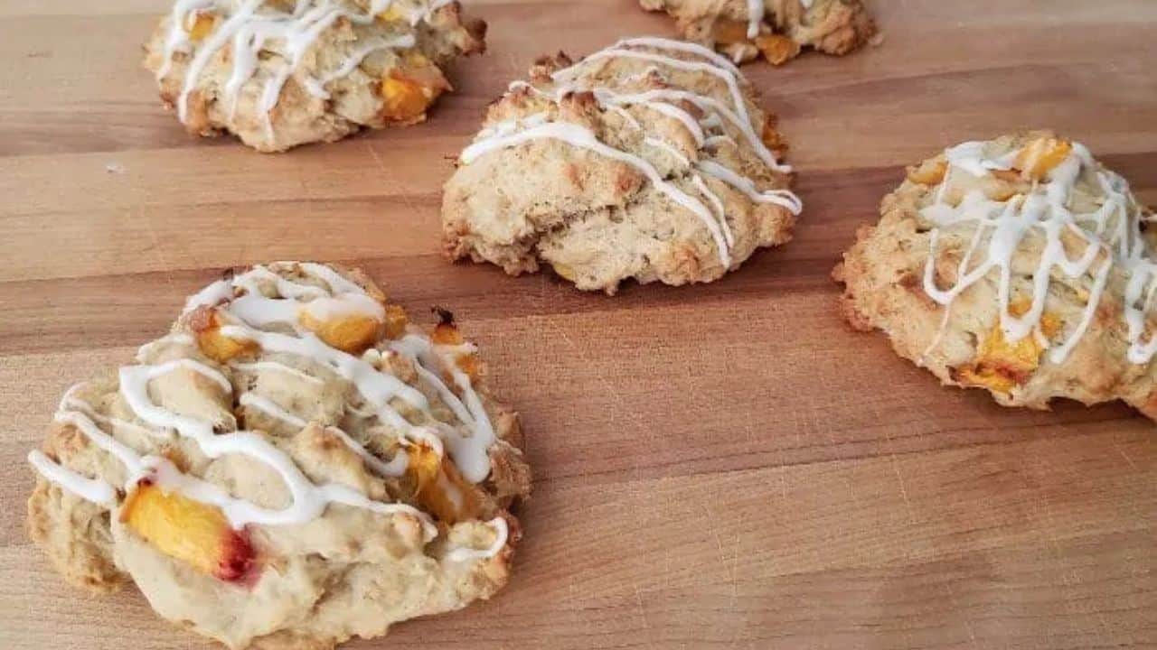Image shows Peach scones with icing on a cutting board.