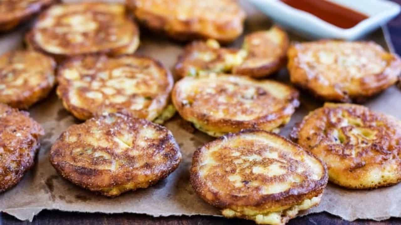 Fried green tomato fritters on a sheet of parchment.