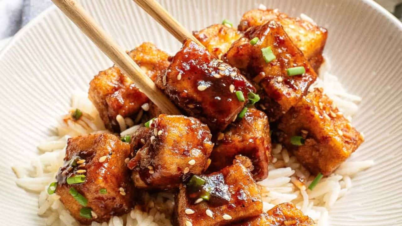 Close-up image of General Tso's tofu in a bowl over rice.