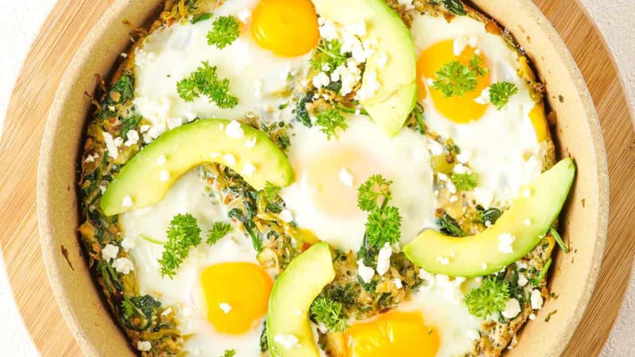 Overhead view of the skillet with spinach shakshuka.